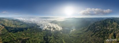 High above clouds above the rice fields