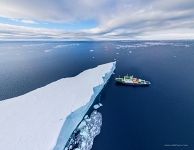 Iceberg and Polar Pioneer expedition ship. Antarctica