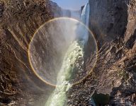 Rainbow in waterfall splashes. Victoria Falls, Zambia-Zimbabwe