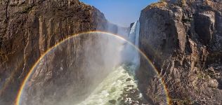 Rainbow in waterfall splashes. Victoria Falls, Zambia-Zimbabwe Rainbow in waterfall splashes. Victoria Falls, Zambia-Zimbabwe