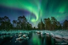Northern lights over a non-freezing river