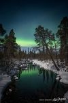 Northern lights over a non-freezing river